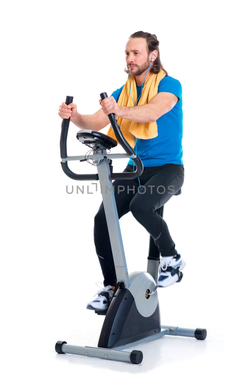 young man in blue shirt train with fitness machine and listening music