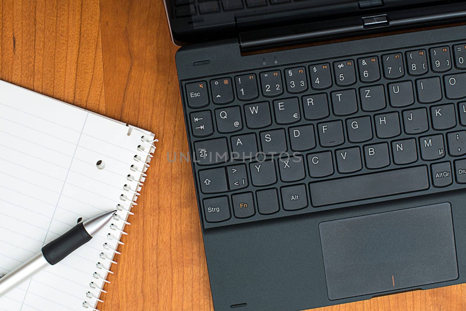 notebook and notepad with pen on wooden table from above