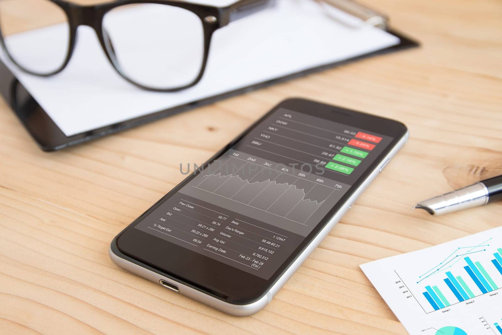 phone and business stock application on work desk