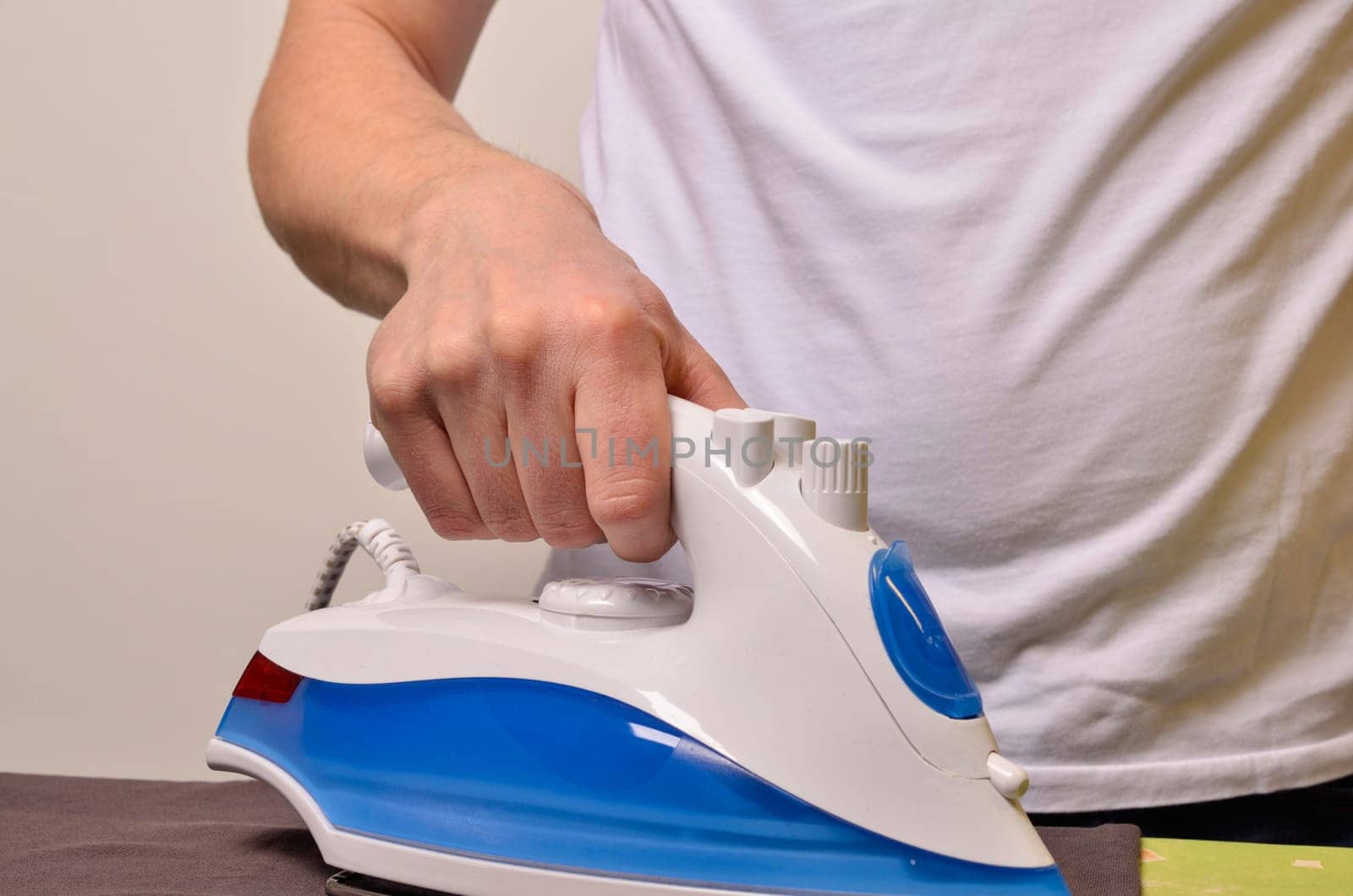 Man ironing his cloth