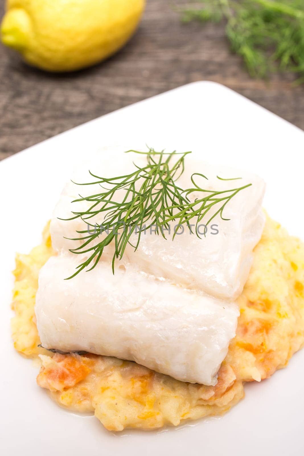 Cod with dill on mashed potatoes in portrait format
