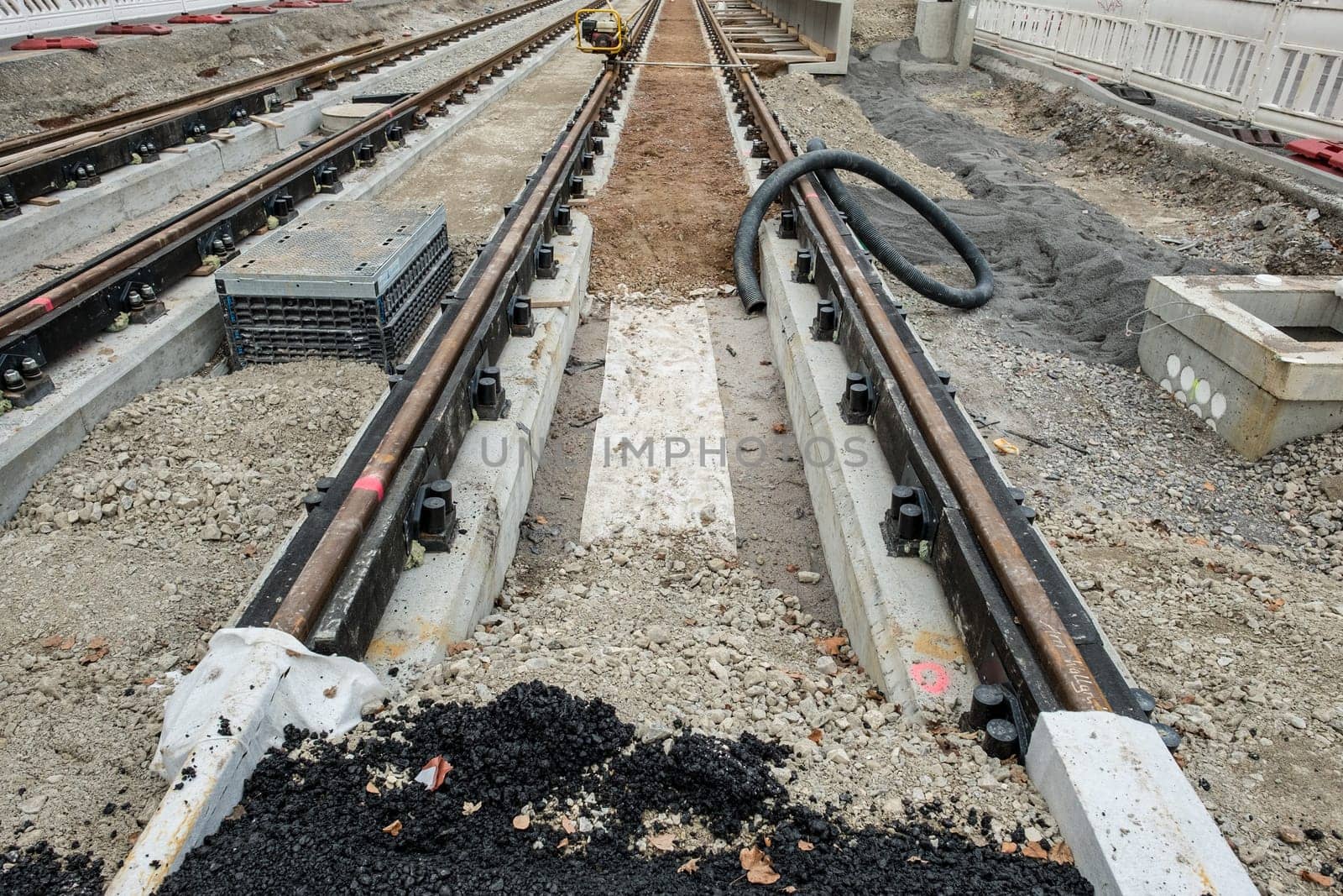 Construction site with tracks and building materials made of gravel and tar