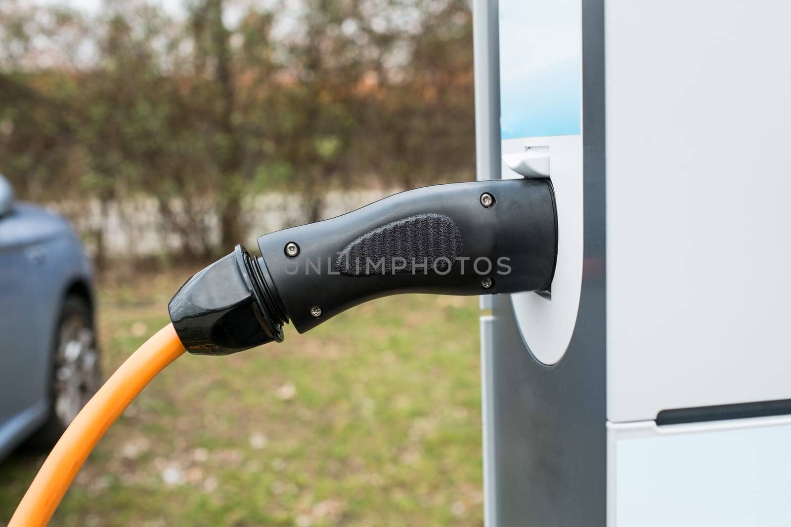 Charging station with plug and cable for charging an electric car