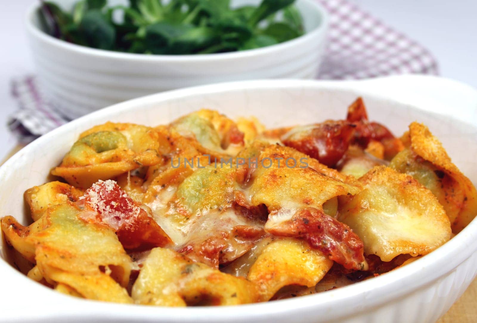 parmesan baked tortellini in tomato cream sauce with lettuce
