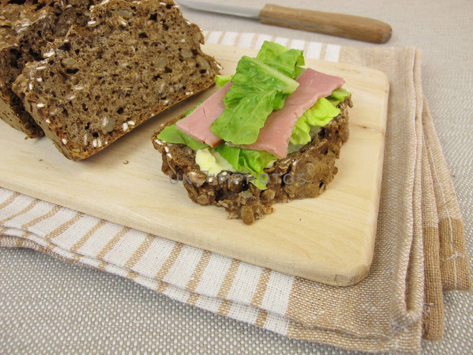 Covered black bread with salmon ham and lettuce leaf