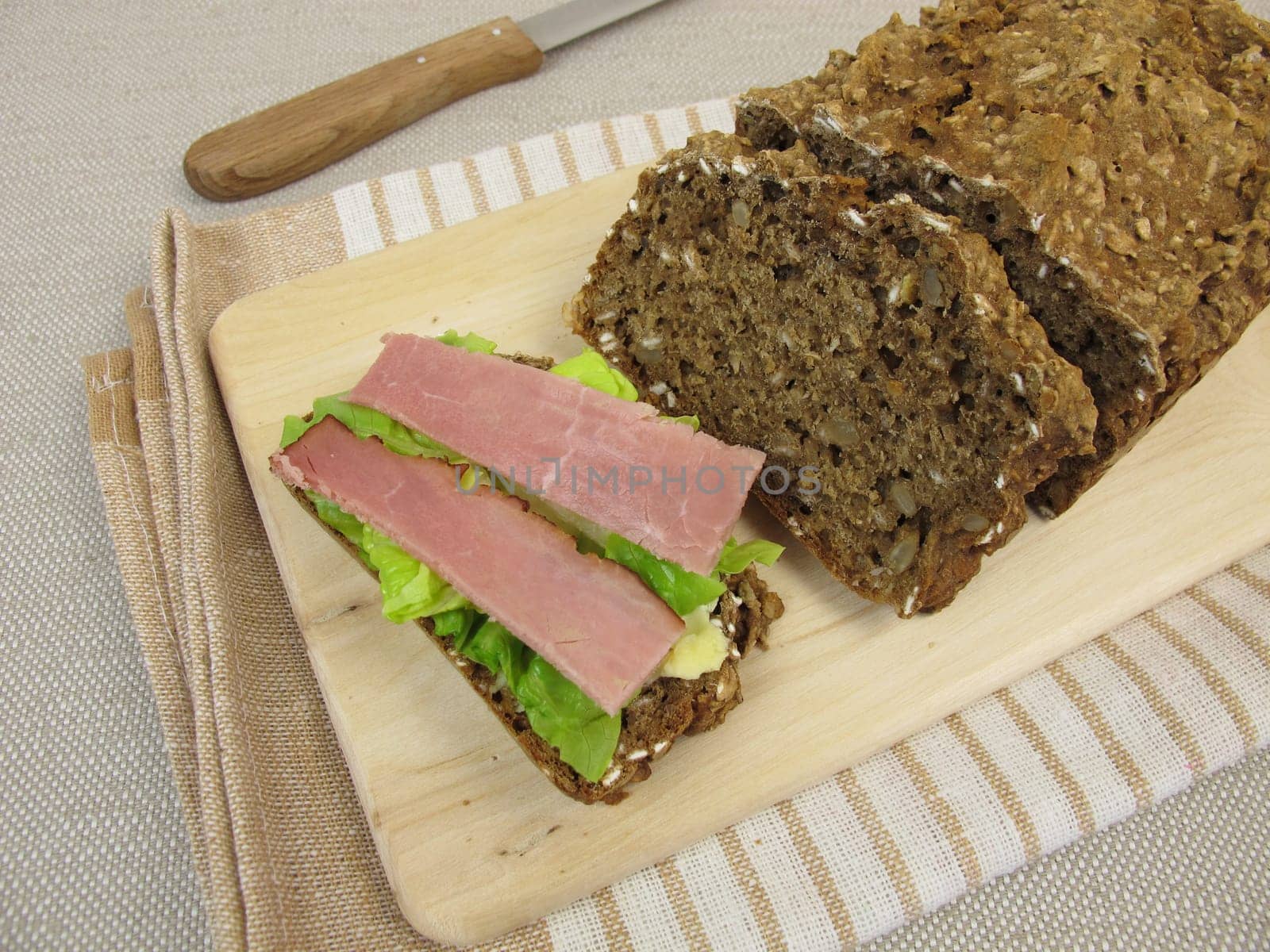 Covered black bread with salmon ham and lettuce leaf