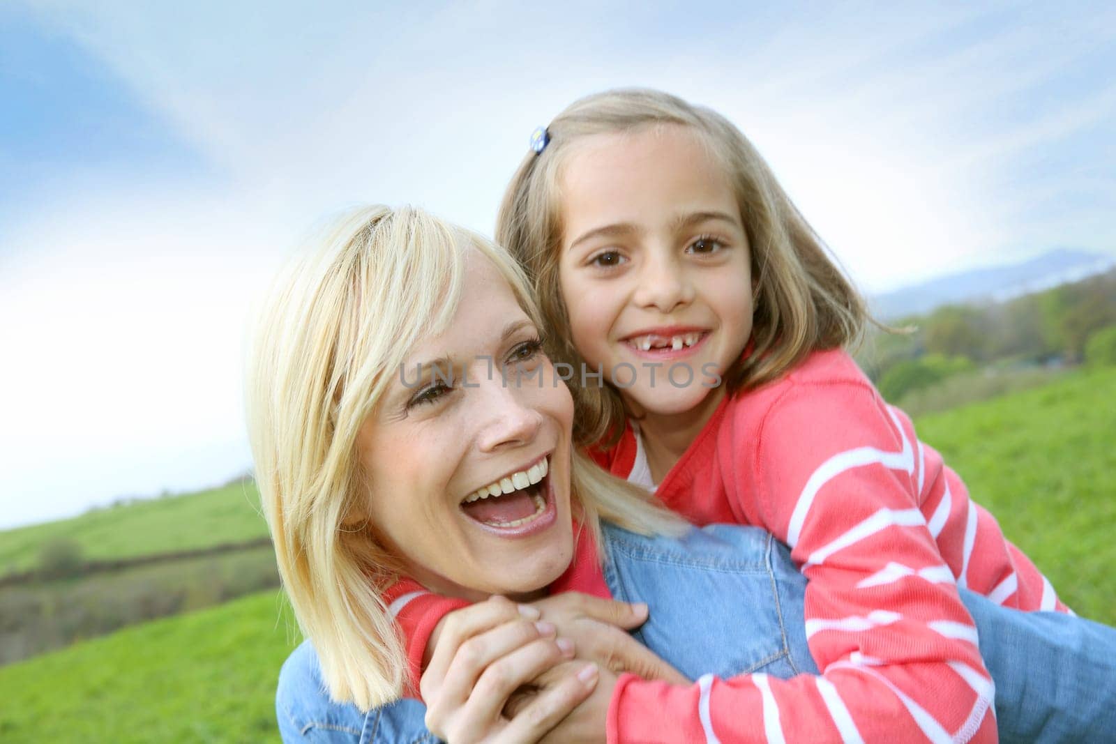 Woman holding daughter on her back