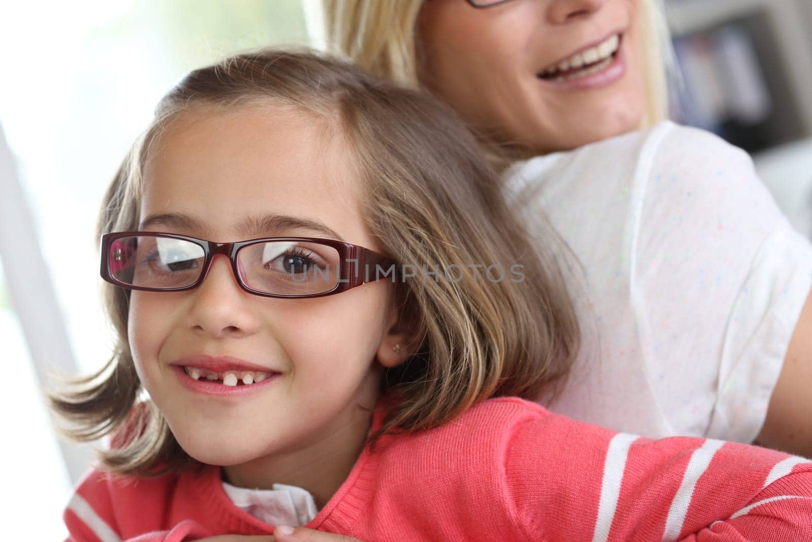 Mother and daughter with eyeglasses on