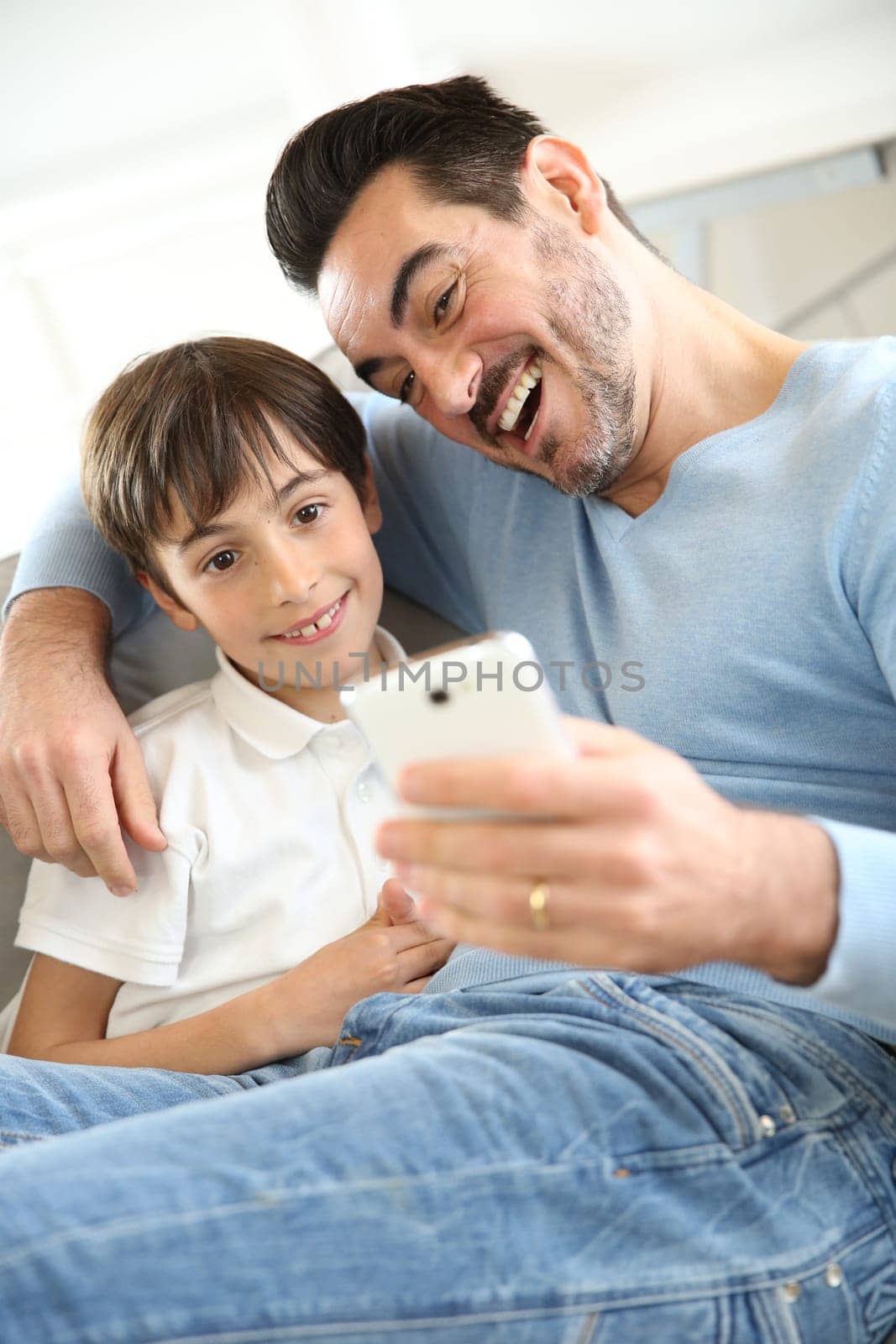 Little boy with dad playing with smartphone