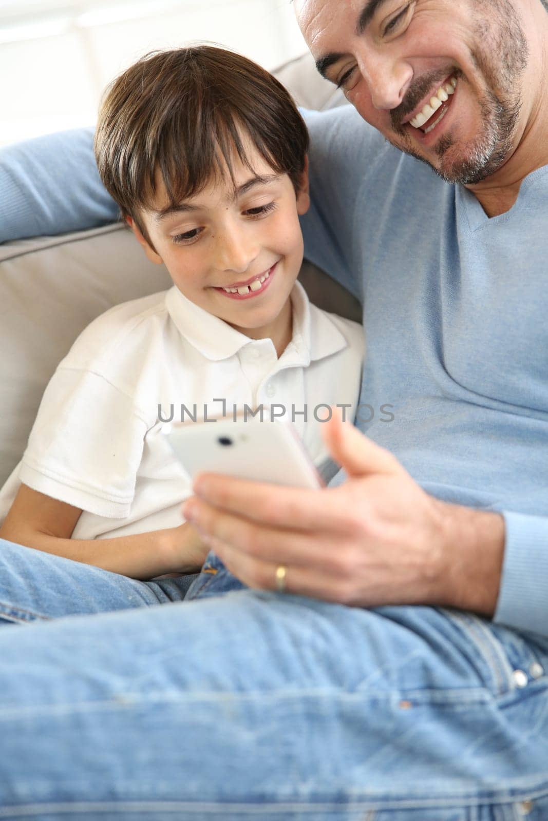 Little boy with dad playing with smartphone