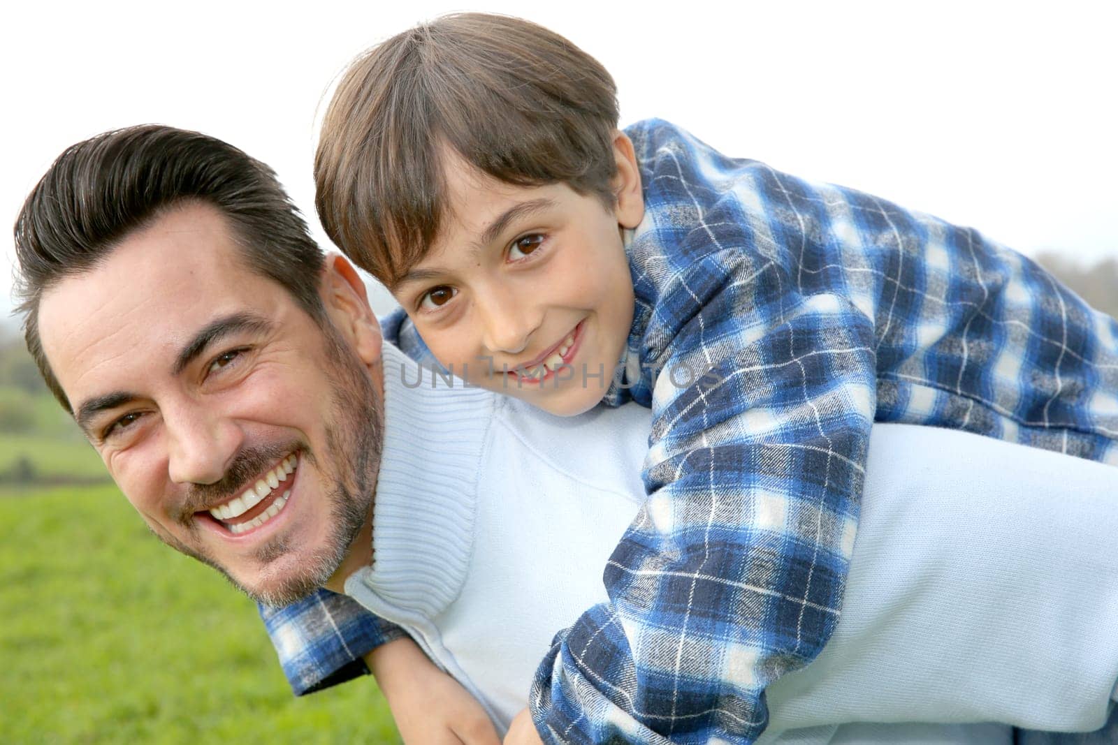 Man holding son on her back