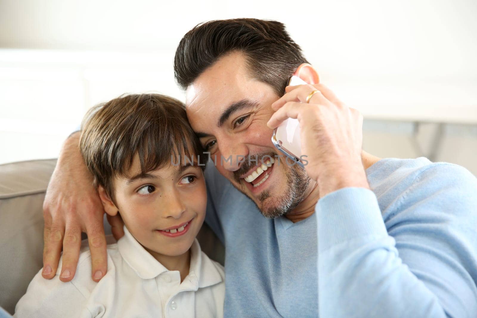 Little boy with dad playing with smartphone