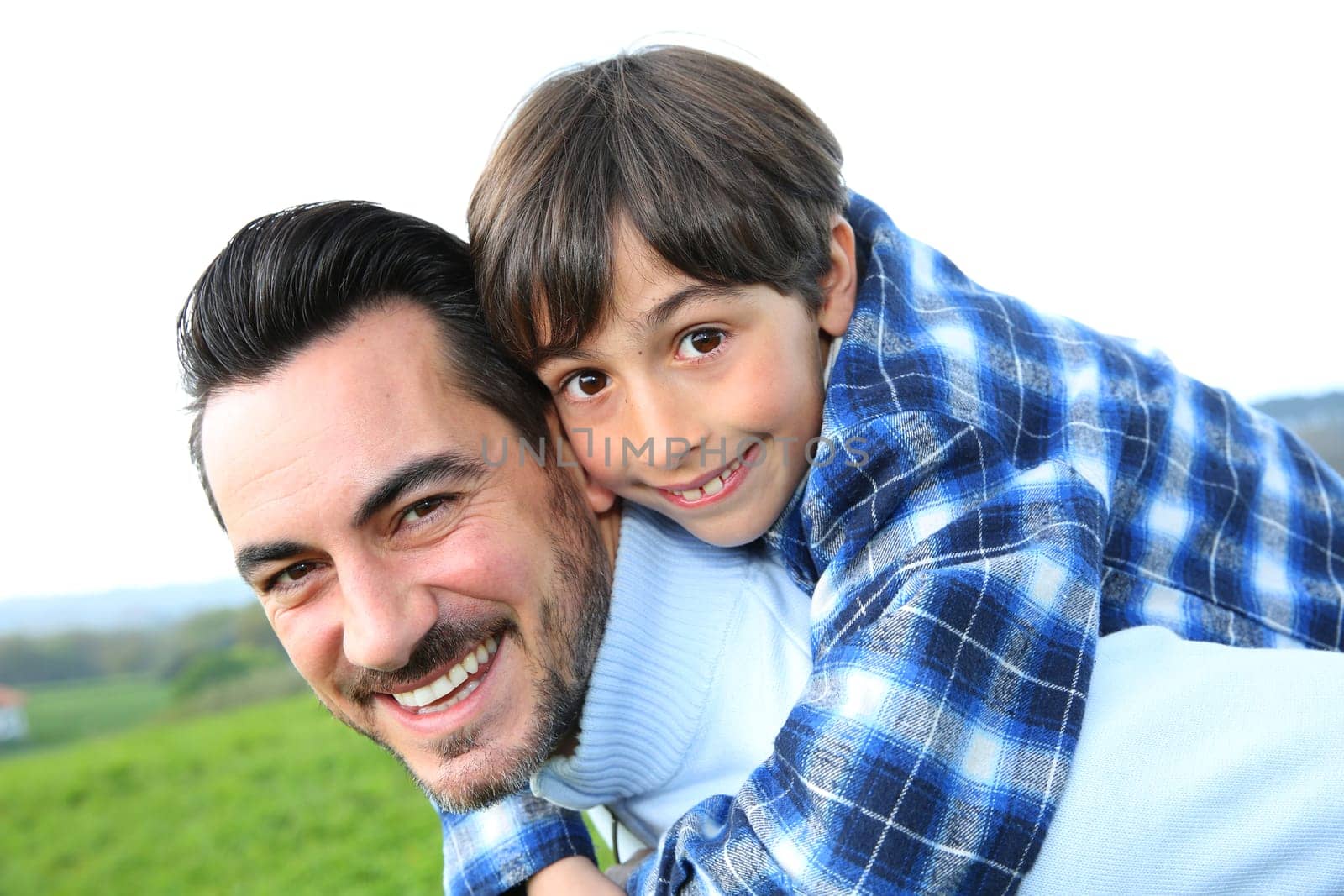 Man holding son on her back