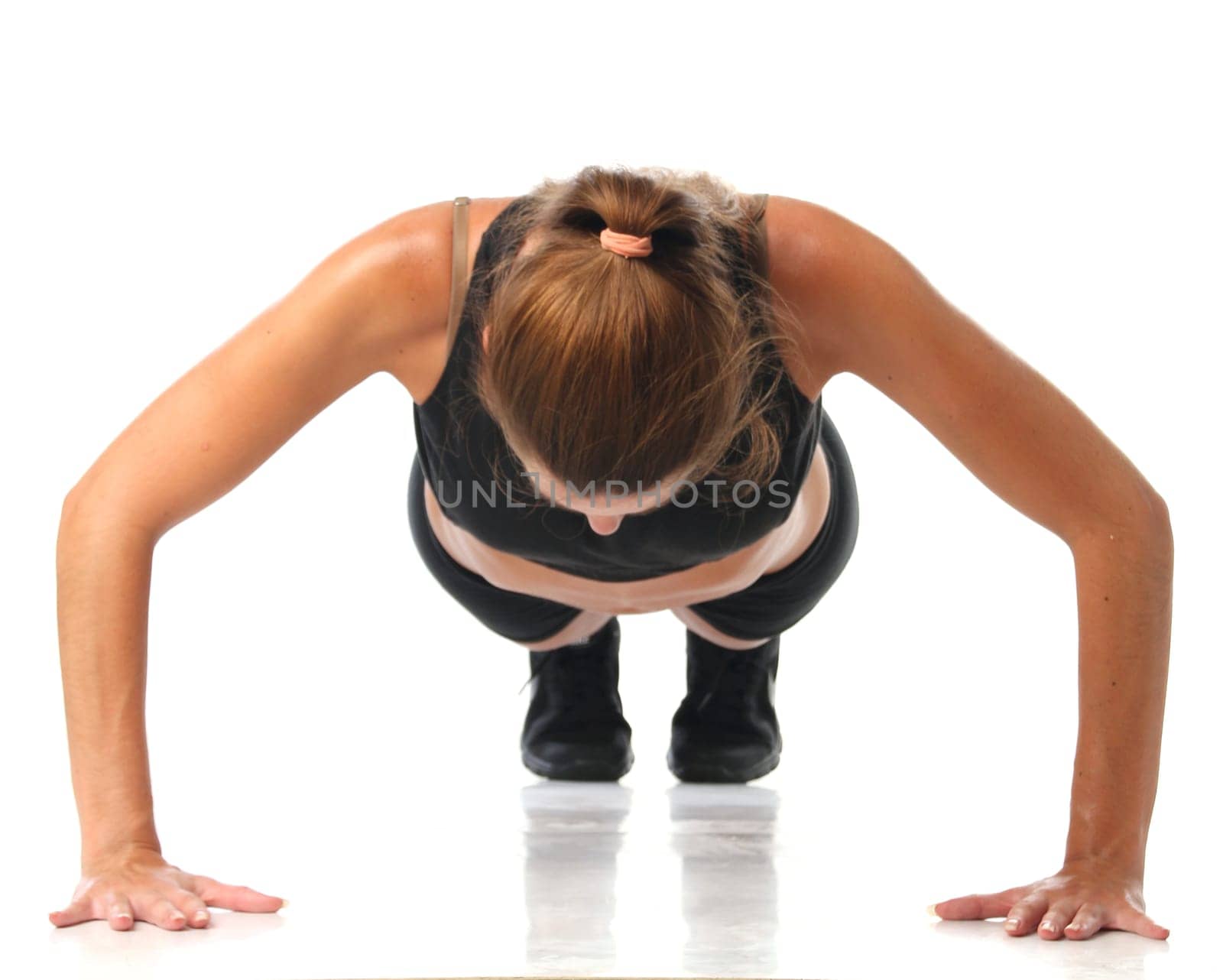 Happy young woman holding doing exercise and stretching over white