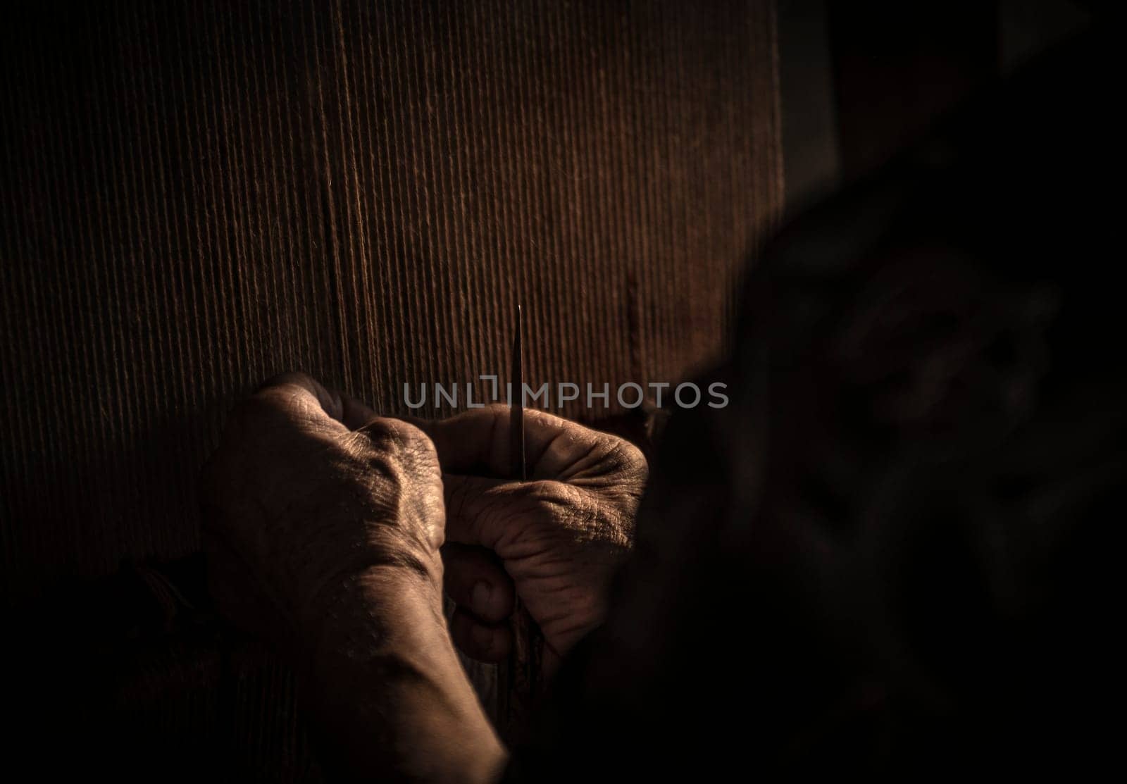 An old ladies experienced hands weaving a traditional Azerbaijani rug