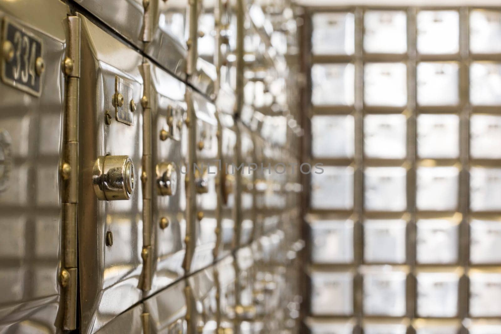 Many po boxes at the post office. The mail boxes are lined up in rows and columns. Selective focus