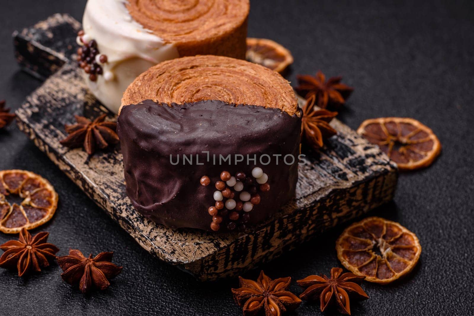 Round sweet New York roll croissant with chocolate cream filling on a dark concrete background