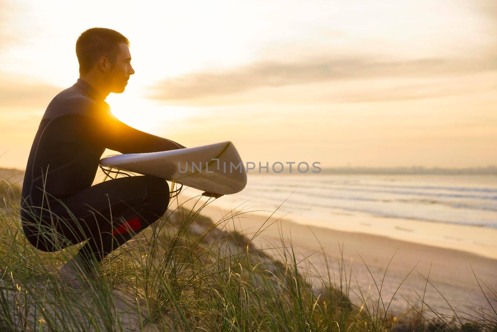 A surfer with his surfboard at the beach