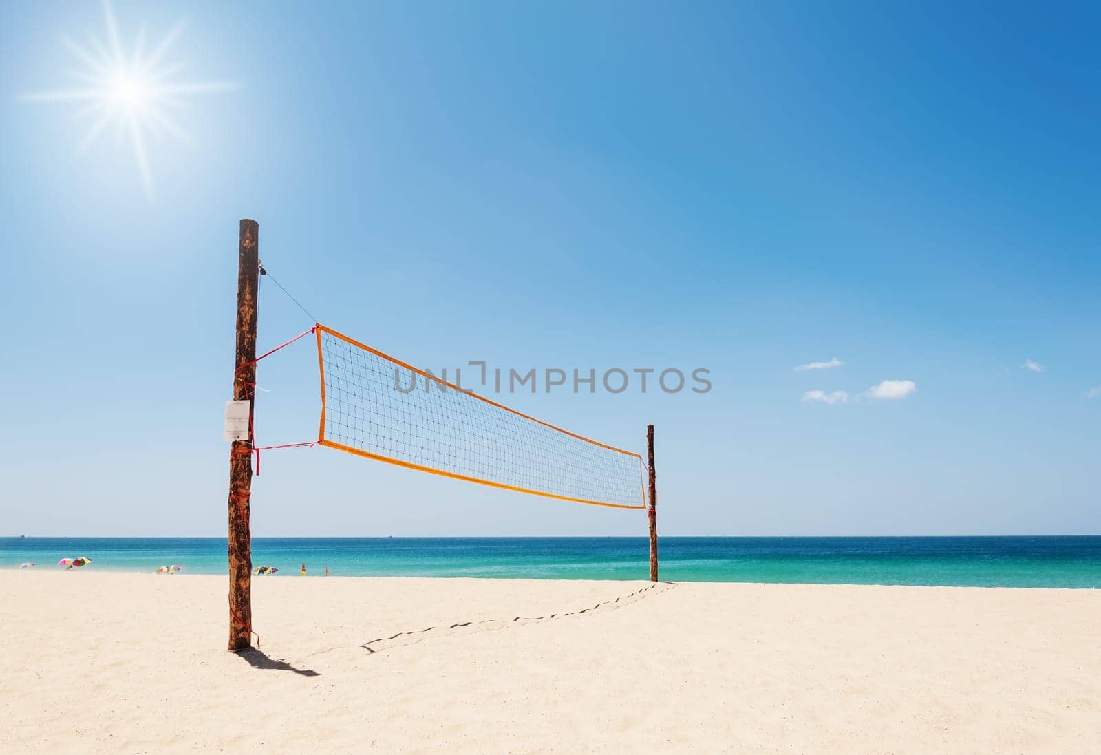 Volleyball net on the beach and tropical sea with overlight the sun