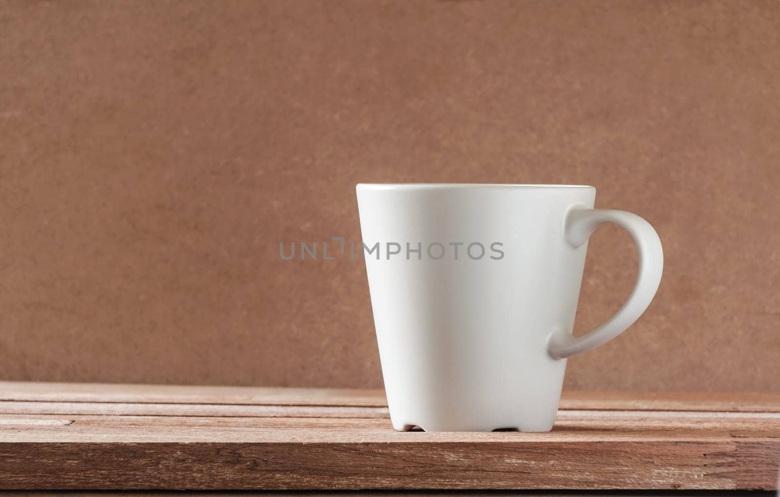 Gray cup on wooden table and blur background, Still life tone
