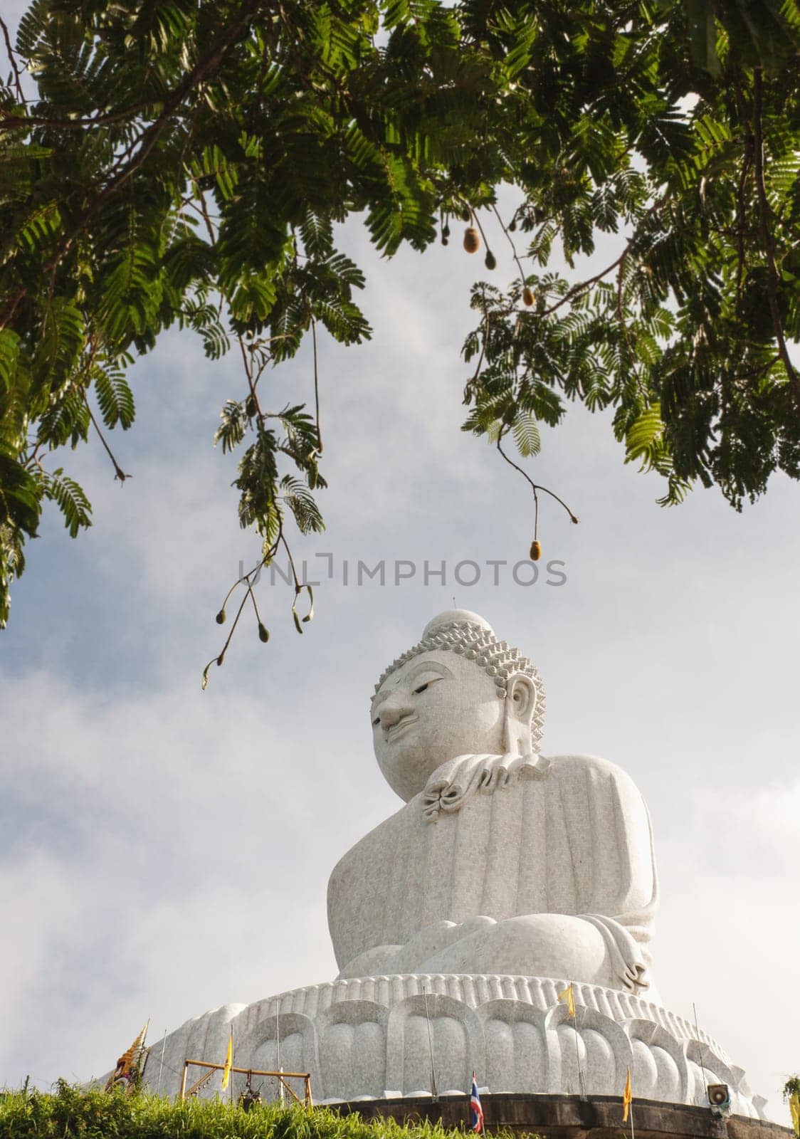 Big buddha in blurred tree border and sky, It is public in Thailand
