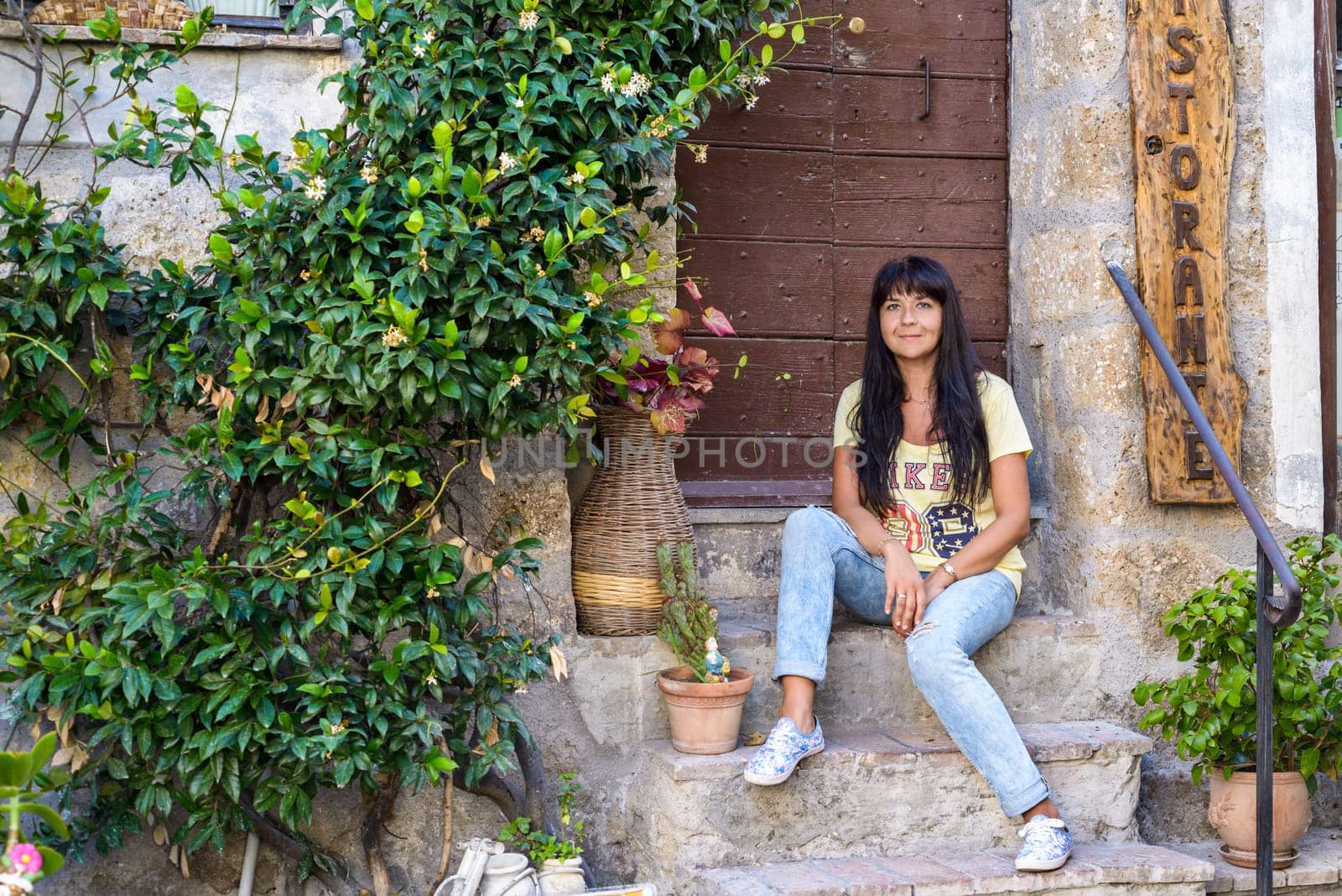 nice girl posing sitting in an ancient village called Calcata, Italy