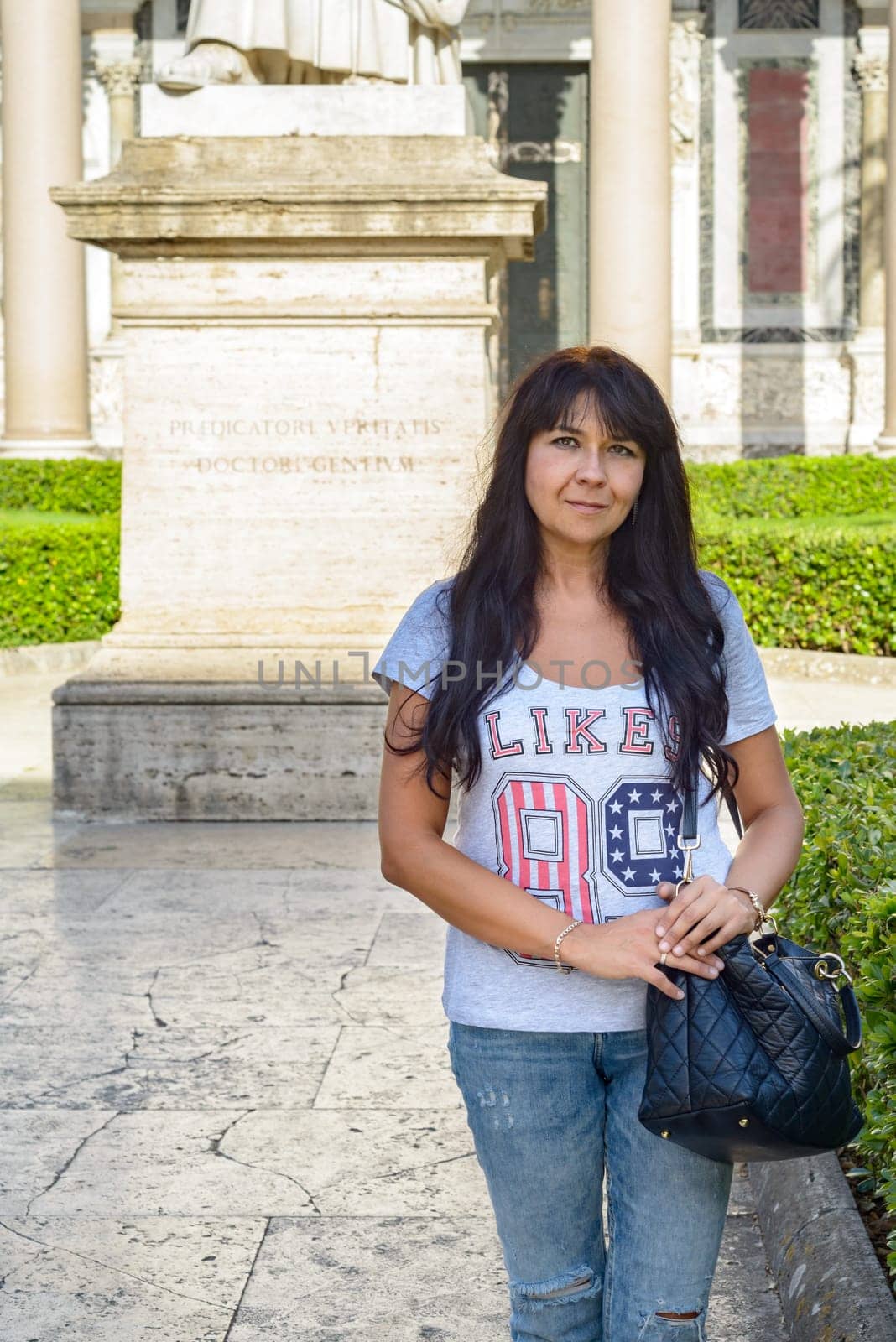nice girl posing in the cloister of saint Paolo (Paul) church in Rome Italy