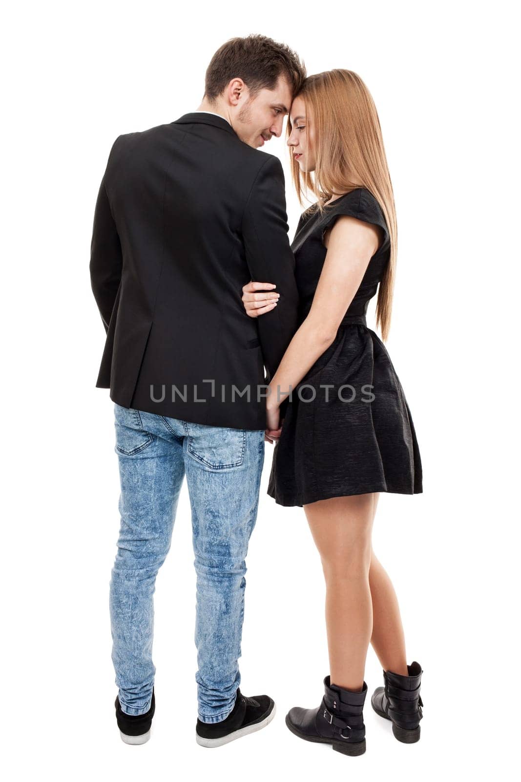 Elegantly dressed young couple standing close to each other