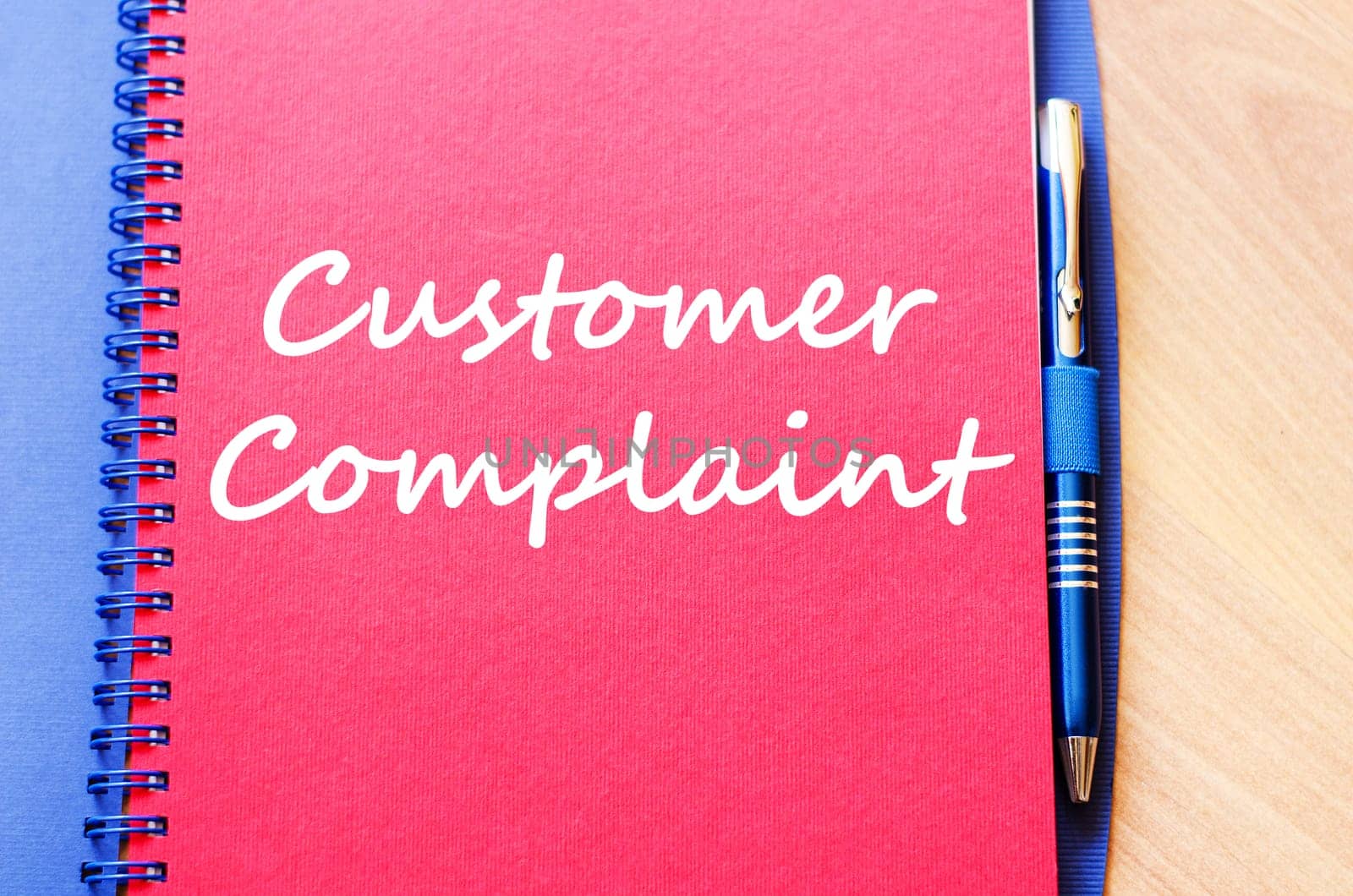 Customer complaint text concept write on notebook with pen