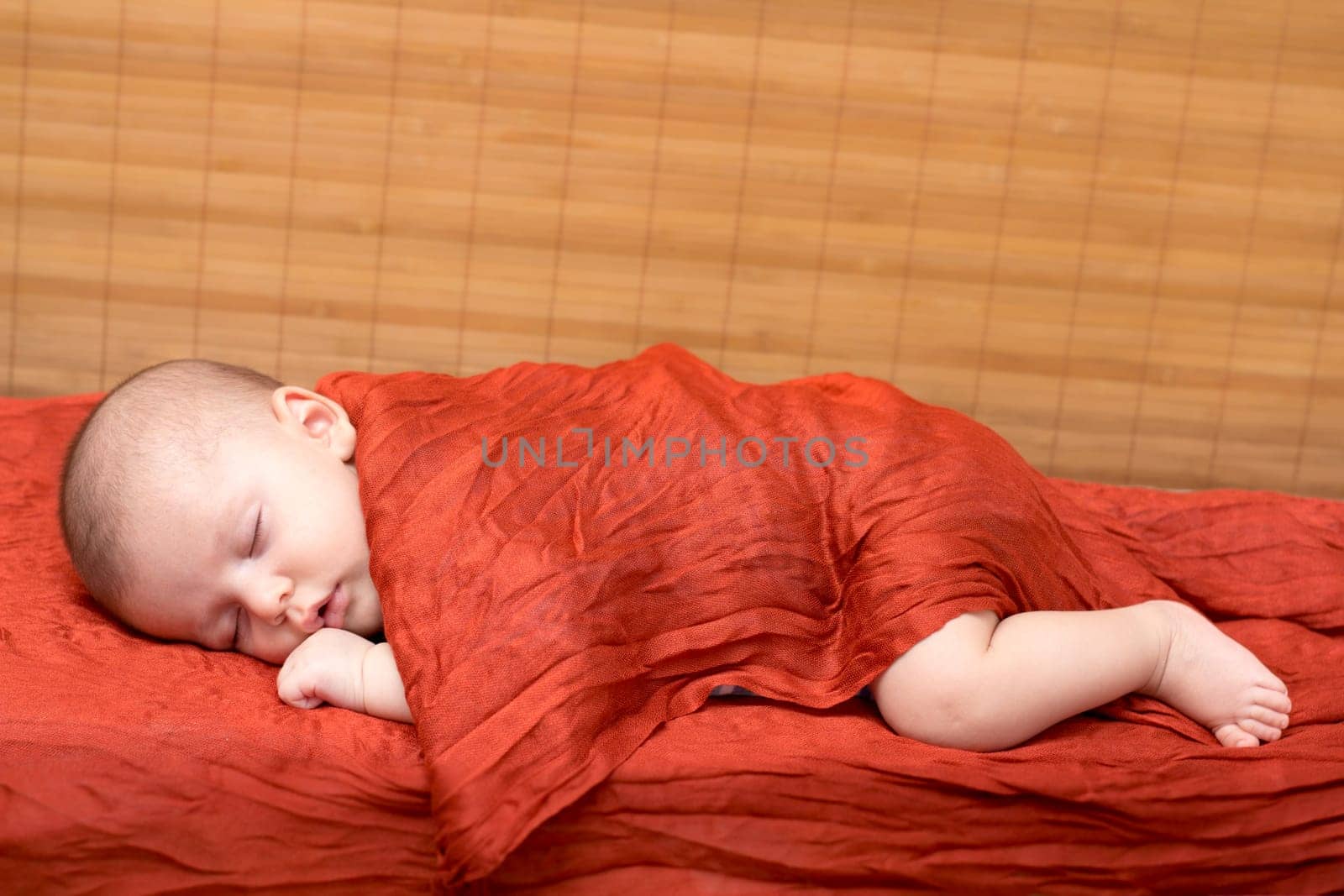 Picture of a newborn baby boy sleeping with copy space