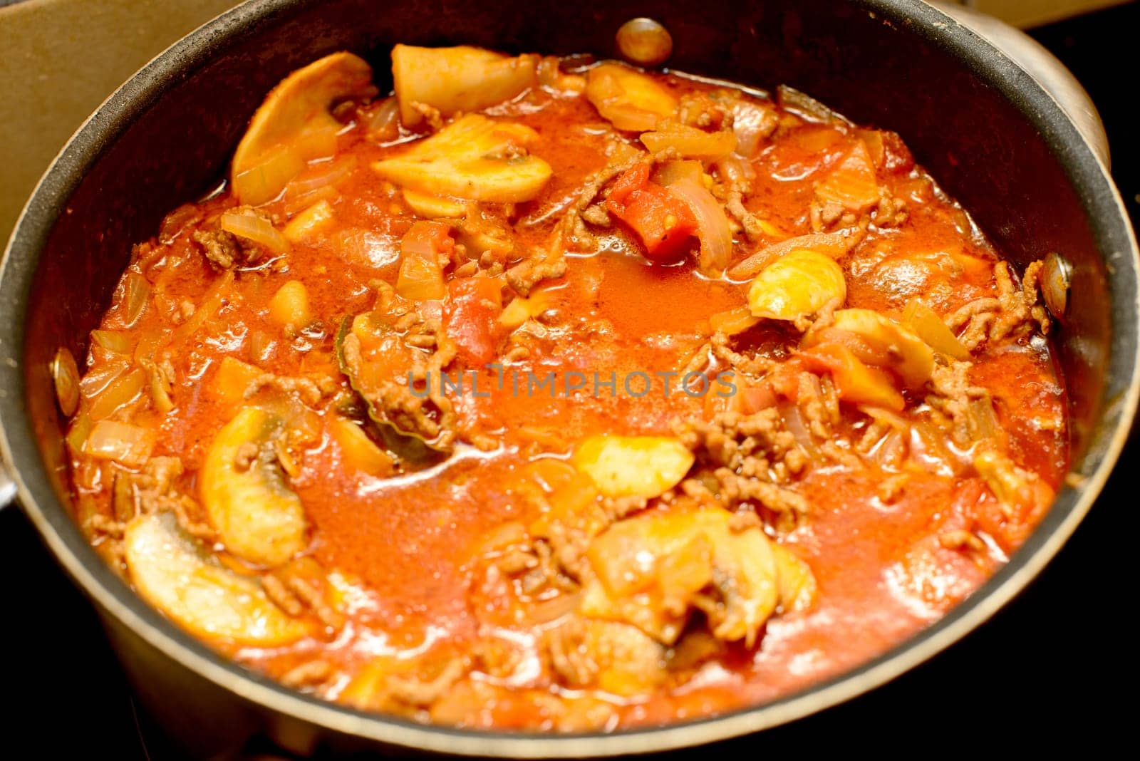 cooking the sauce for lasagne in a pan