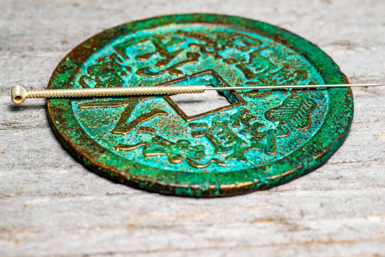 Acupuncture needle on ancient Chinese coin