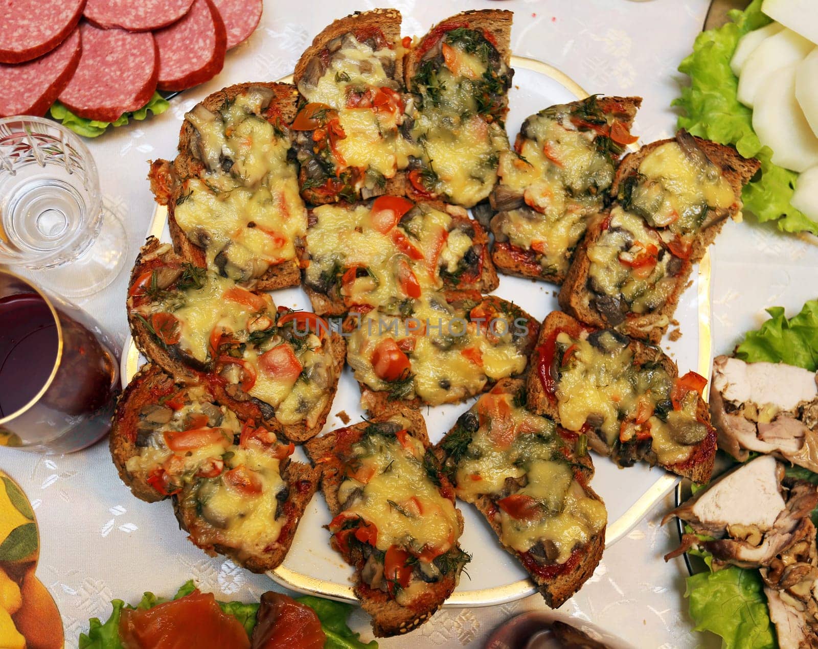 Delicious sandwiches with mushrooms and cheese on a large plate