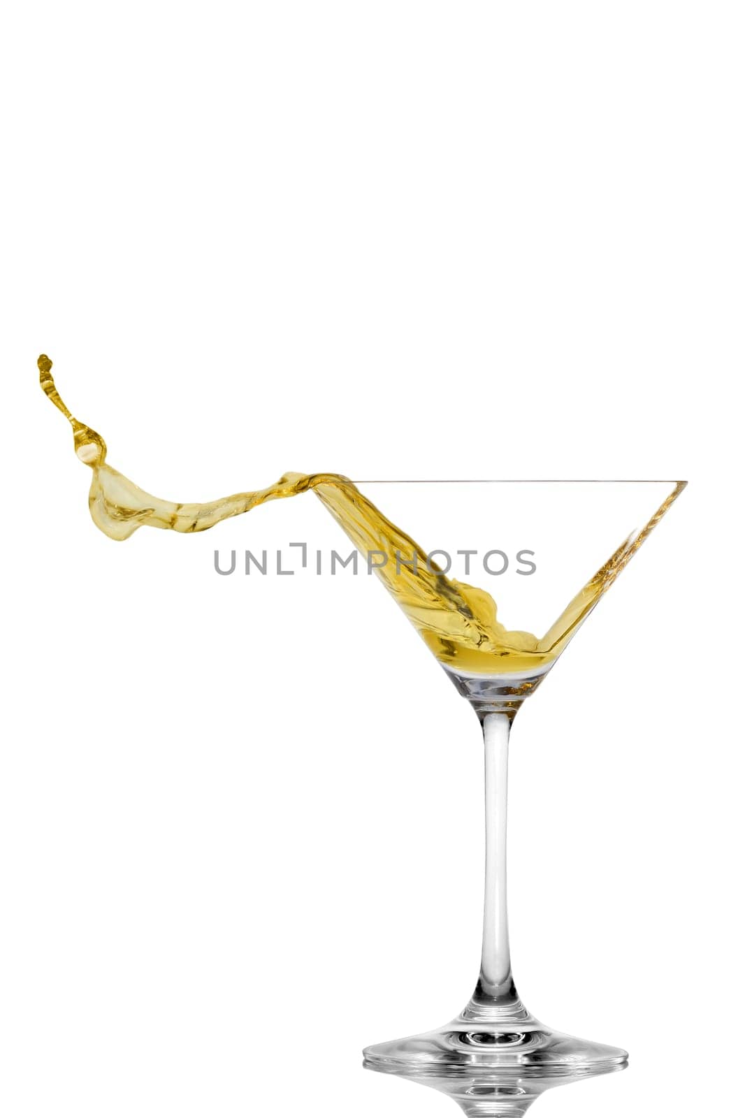 Martini is splashing out of a glass horizontally