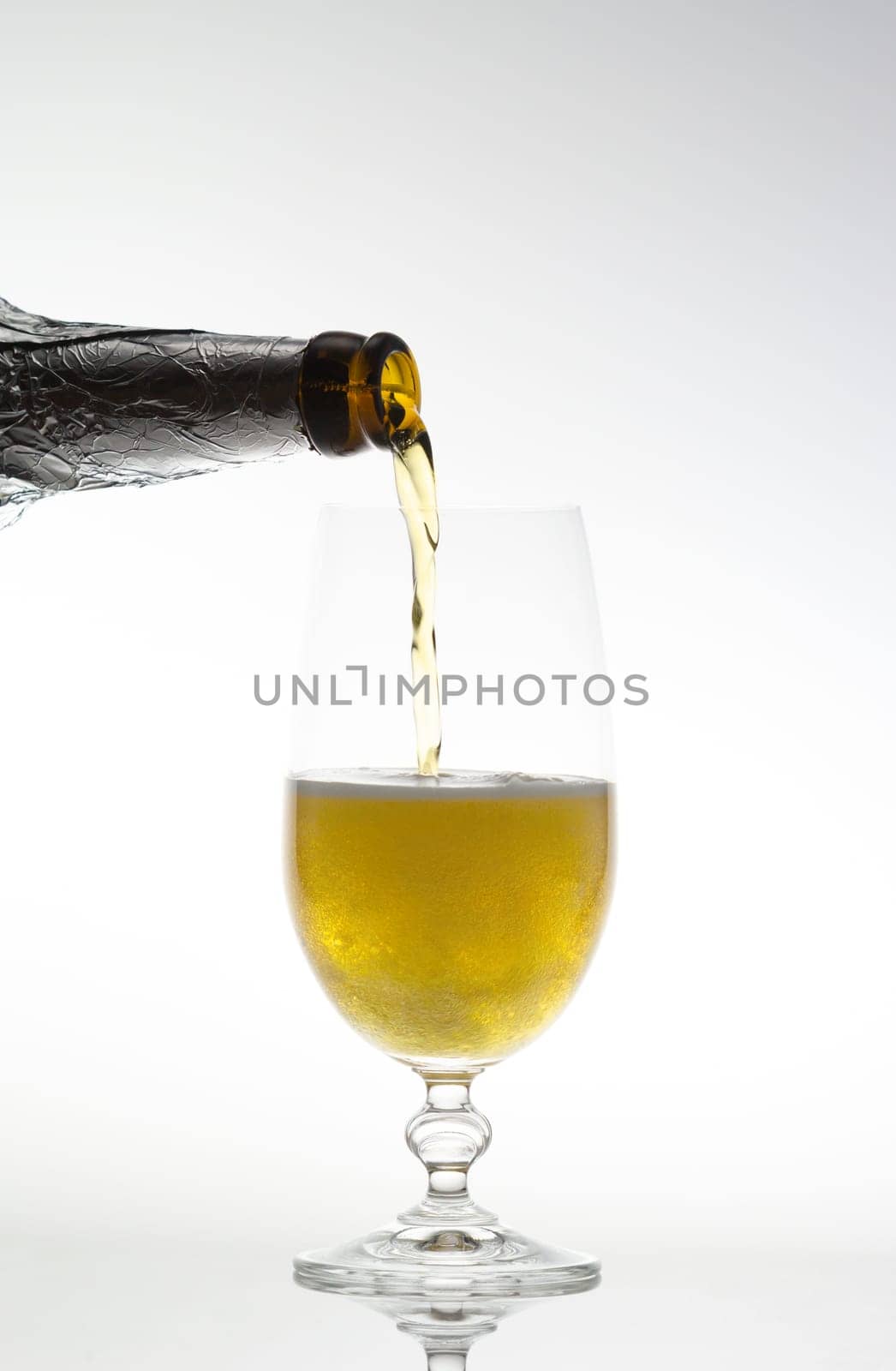 Pouring beer into a glass with a bottle