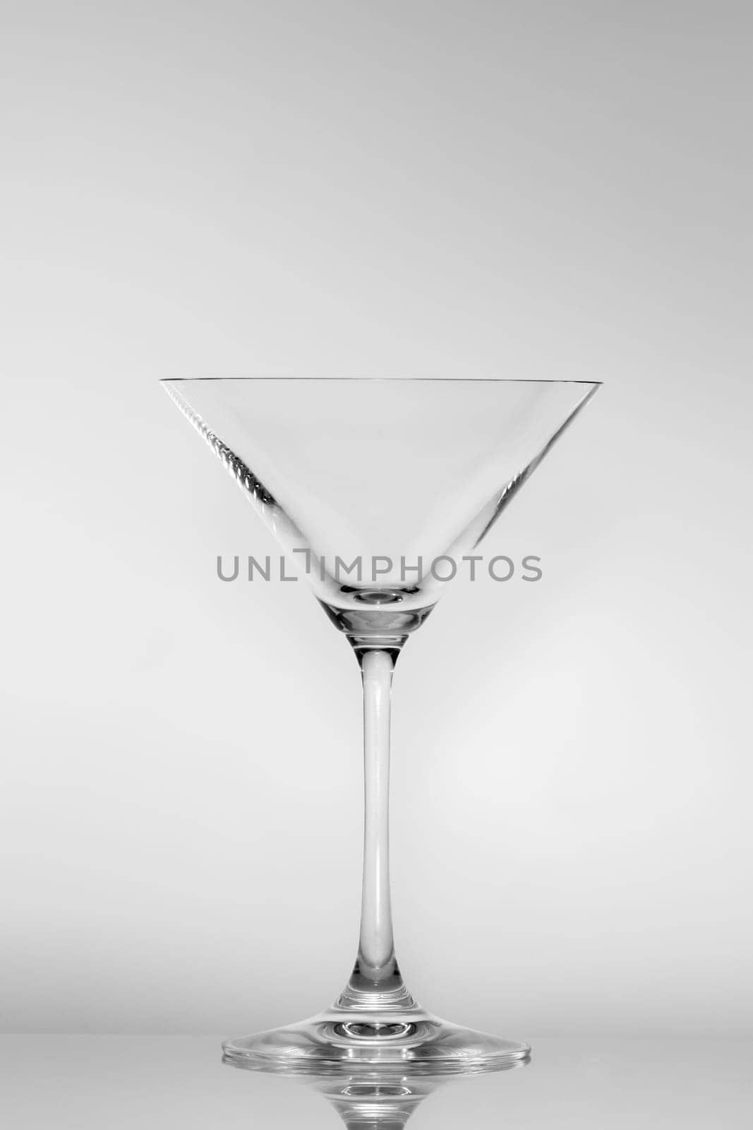 Empty Martini glass on a gray neutral background