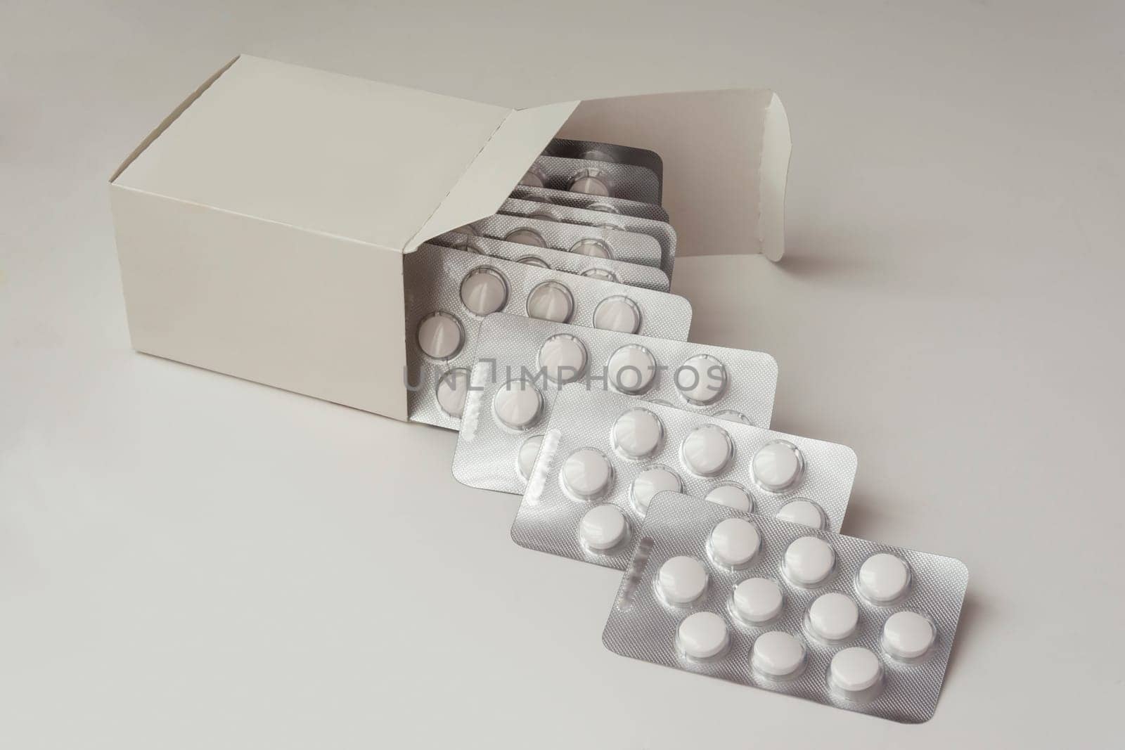 Multiple Loafs of Tablets Getting Out Form the Box over gray background with shadow.