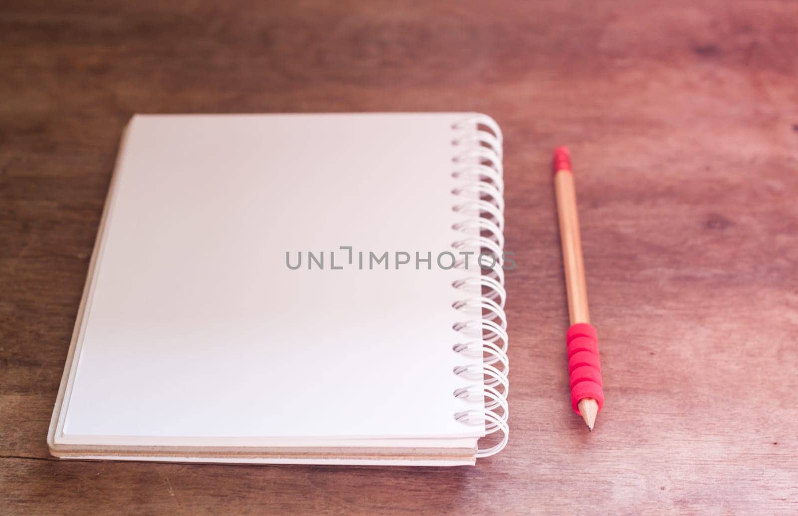 Work station with notebook and pencil with vintage filter, stock photo