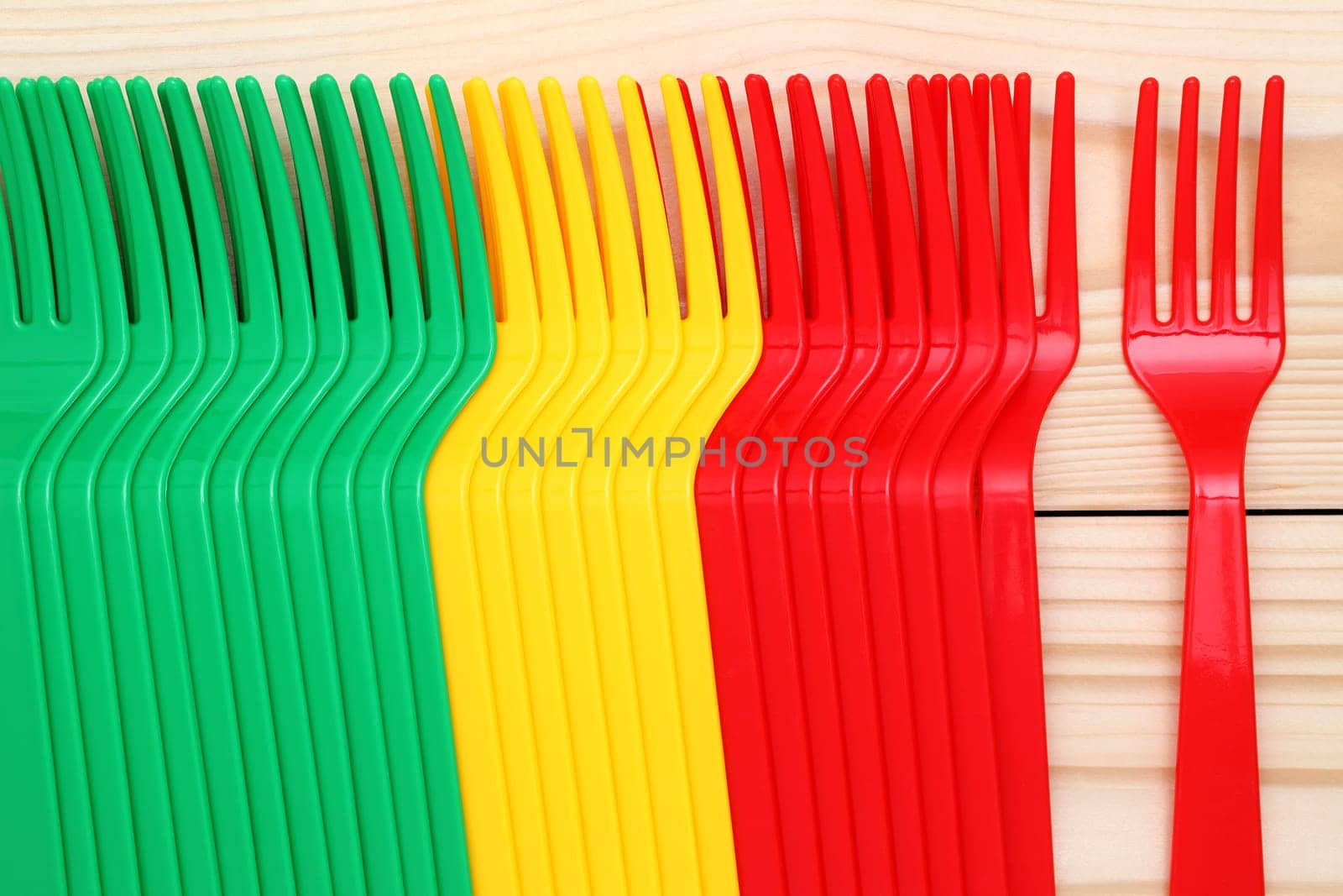 plastic colorful forks on wood background