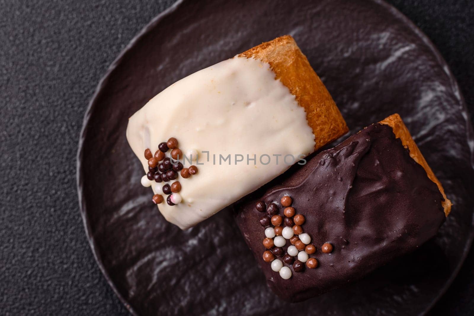 Round sweet New York roll croissant with chocolate cream filling on a dark concrete background