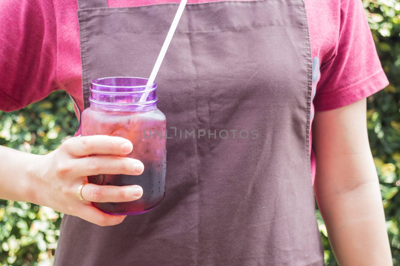 Barista serving iced black coffee, stock photo