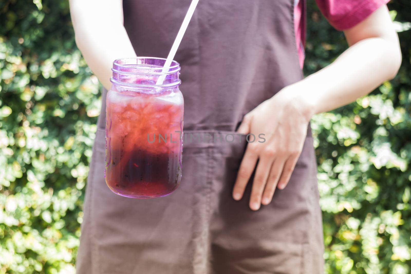 Barista serving iced black coffee, stock photo