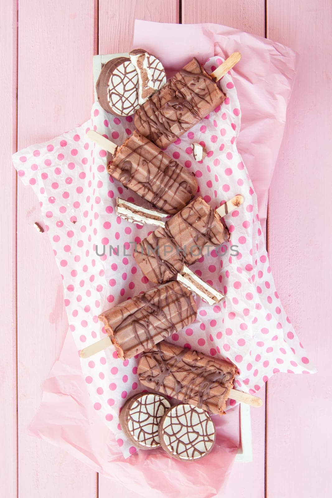 Homemade ice cream on the stem with chocolate on dots paper