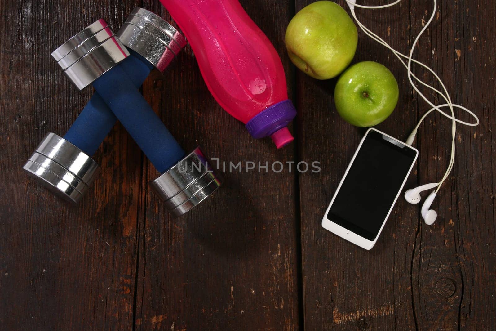Fitness concept. Various elements over a wooden background