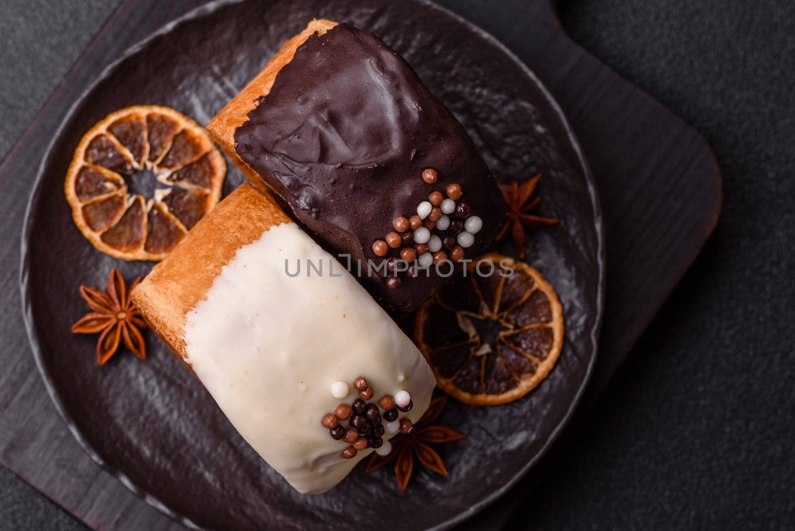 Round sweet New York roll croissant with chocolate cream filling on a dark concrete background