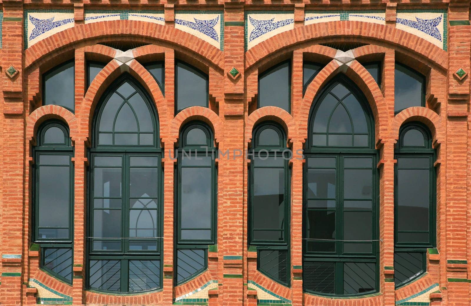 Windows detail of a modernism red brick building. Barcelona, Spain