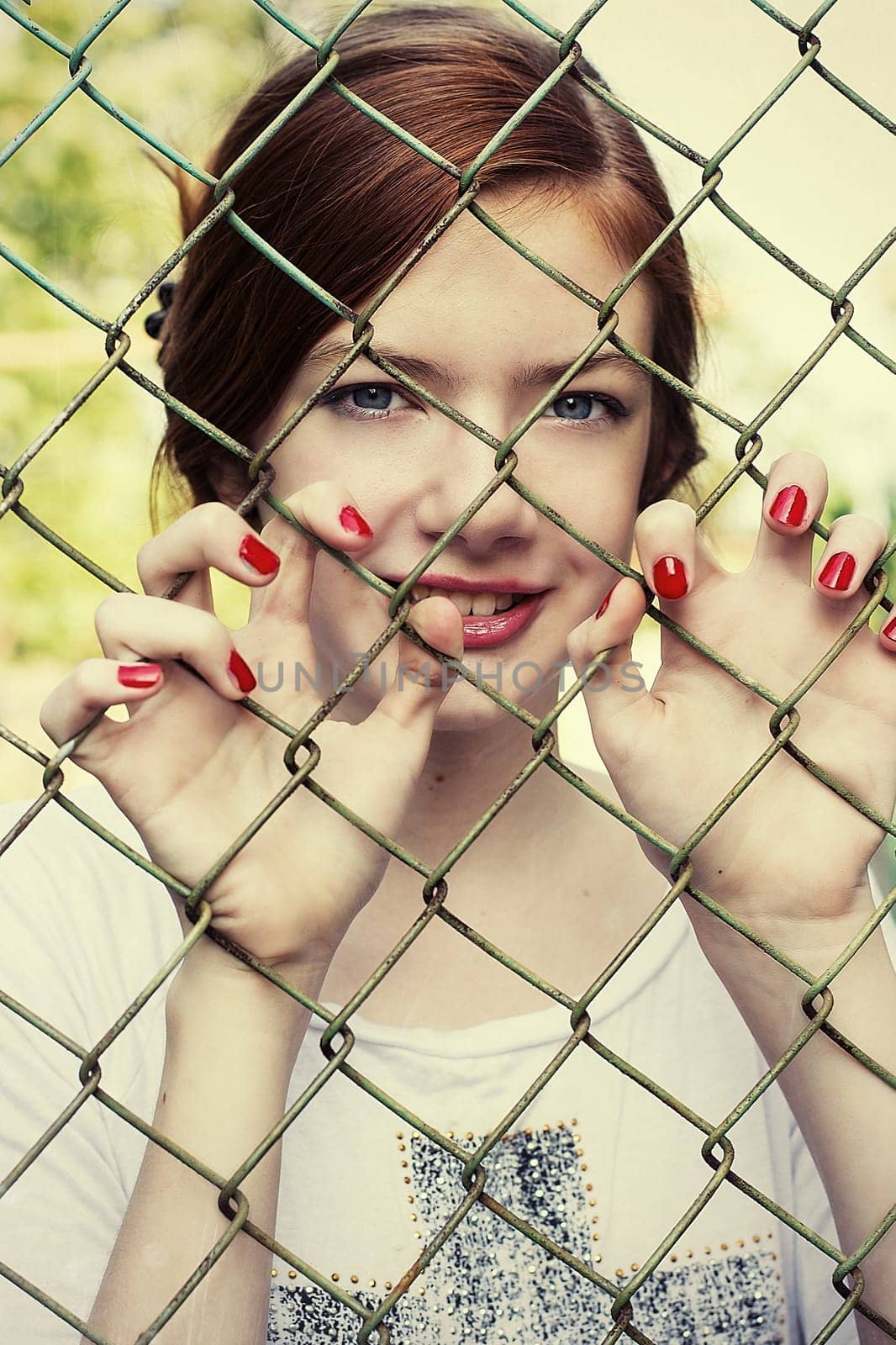 charming girl teen posing outdoors in bright sunlight