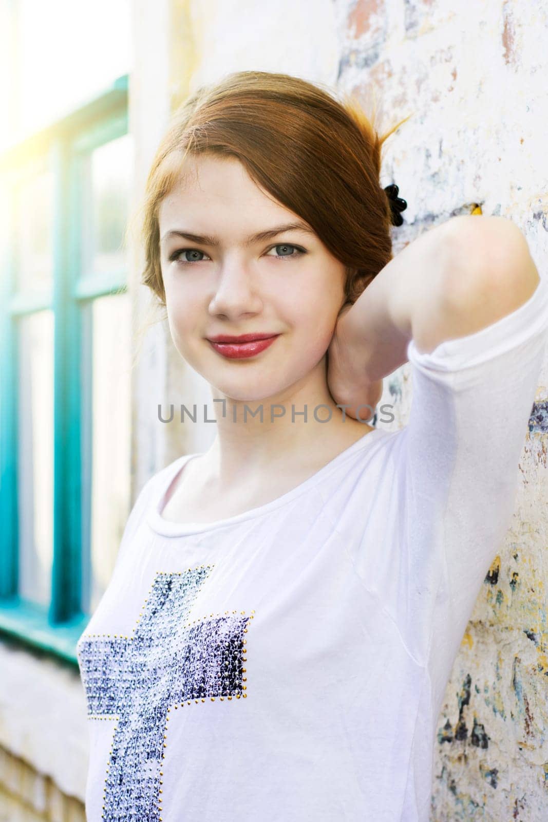 charming girl teen posing outdoors in bright sunlight