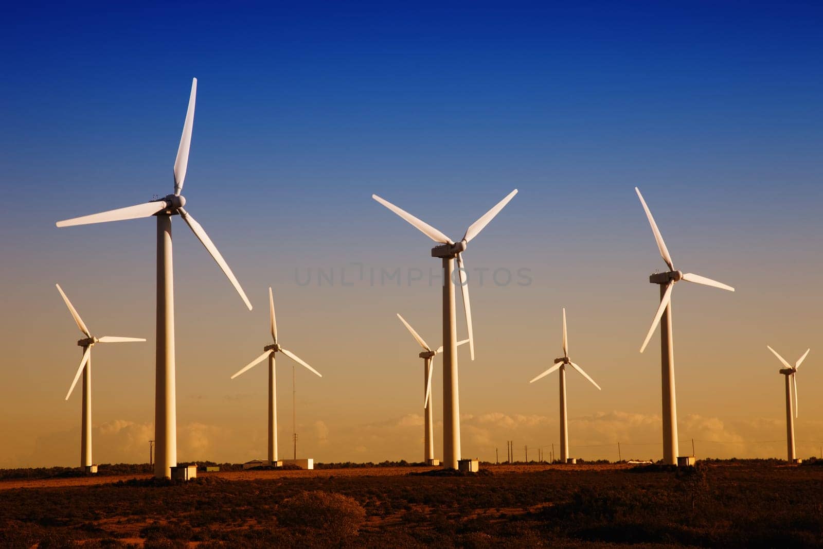 white wind turbines in the top of the mountain