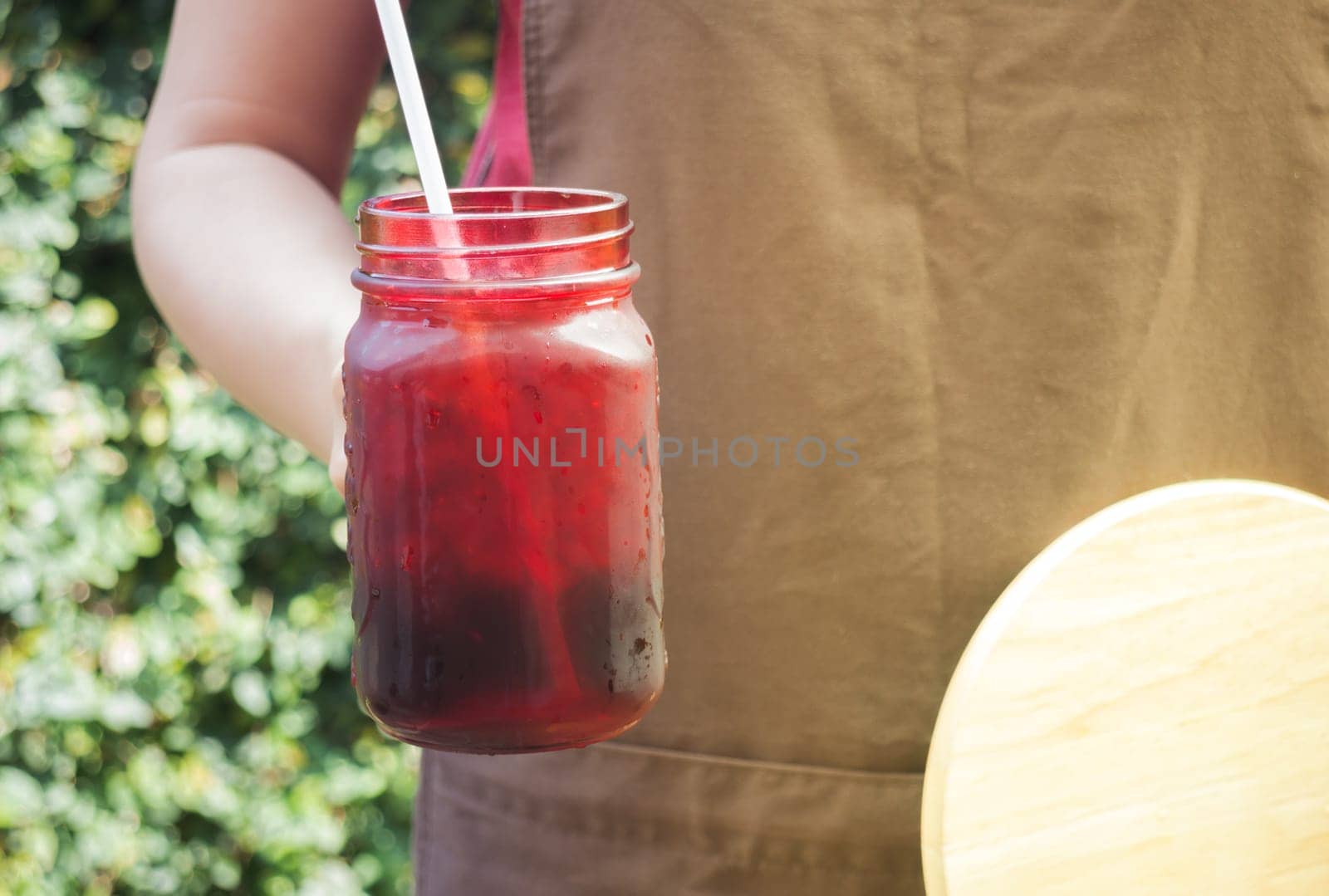Barista serving iced black coffee with vintage filter effect, stock photo